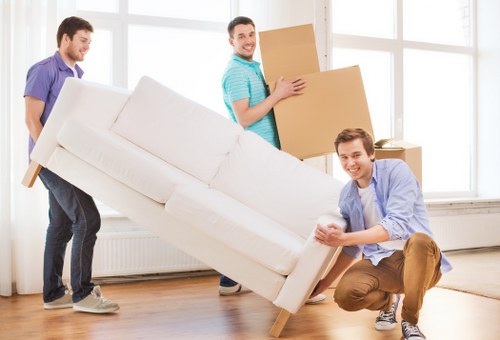 Local movers carrying student belongings in a residential area