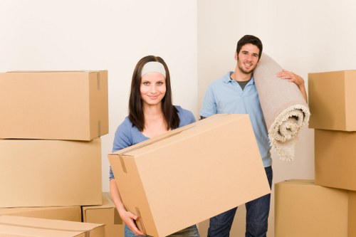 Team handling office furniture and business items during a local relocation