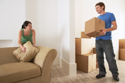 Packed moving boxes and furniture ready for truck loading in Ilford